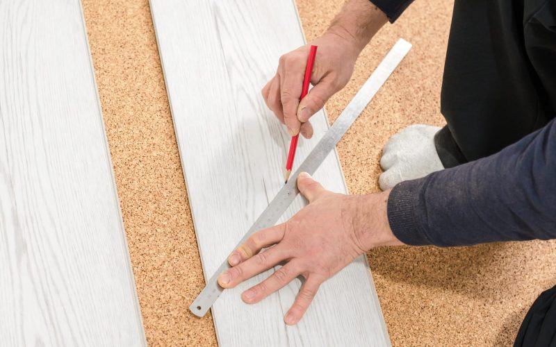 Unrecognizable man laying laminate flooring. Professional laying of flooring - laminate